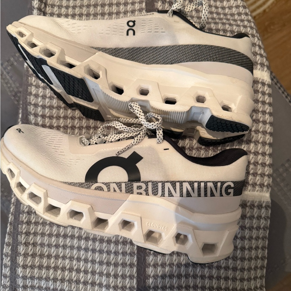 On Running Cream and Black Athletic Shoes